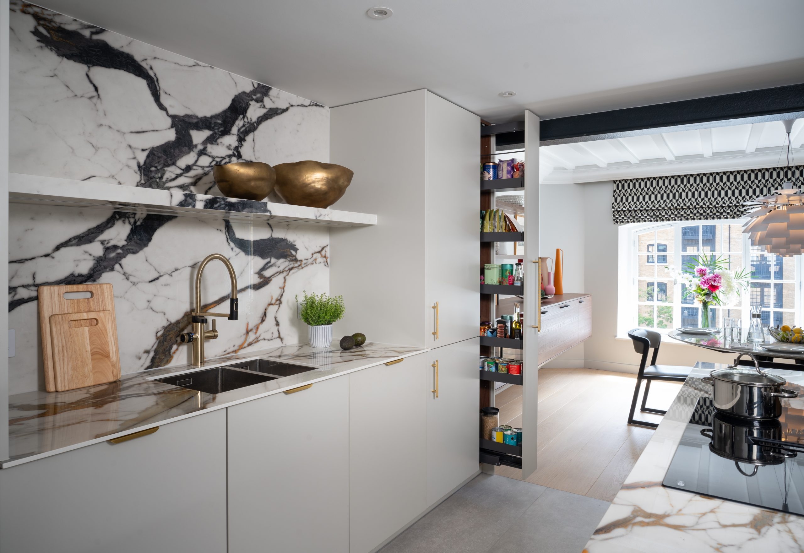 Modern luxury kitchen featuring marble countertops, sleek cabinets, and elegant decor.